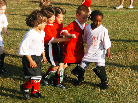 Young soccer players wearing the Code Four Athletics reversible soccer jersey. Young soccer players wearing the Code Four Athletics reversible soccer jersey.